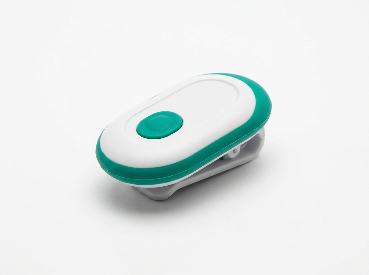 Finis Tempo Trainer Pro device — small oval electronic swim pacing tool that clips to goggles